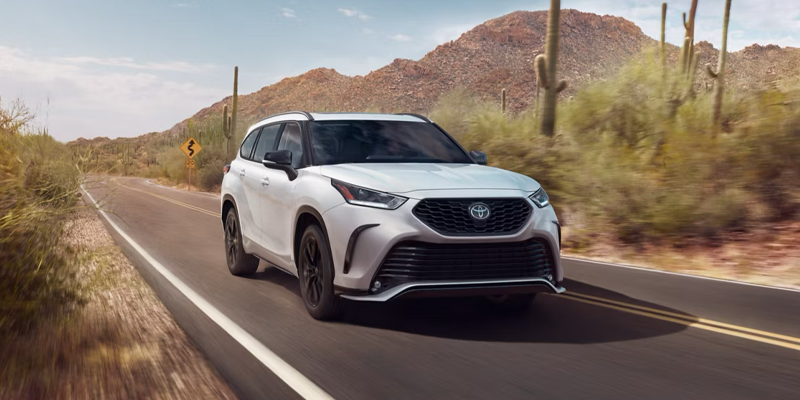 A Toyota Highlander drying on the road through a desert