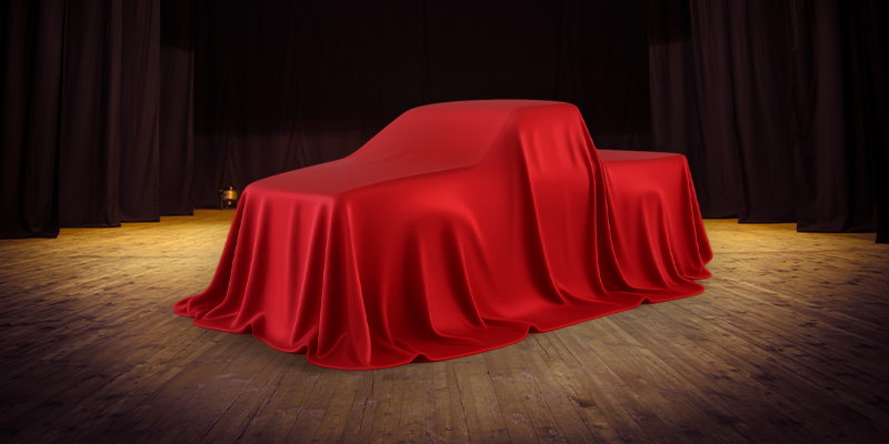 A Toyota truck hidden under red covers.